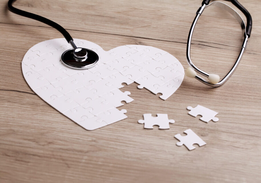 Stethoscope on puzzle, solving the mystery of health care