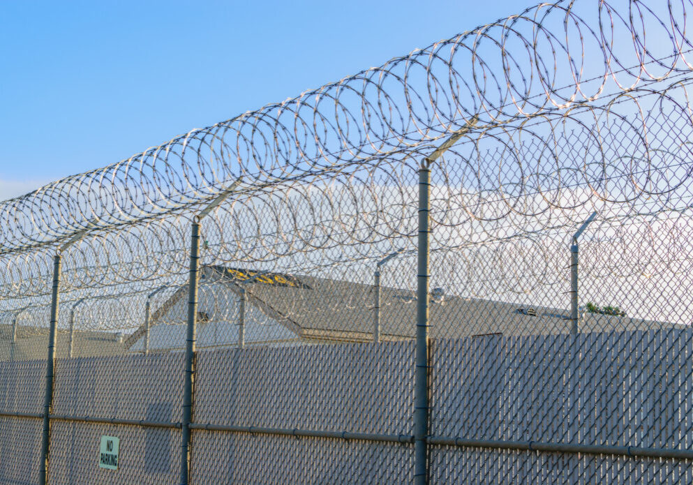 Barbed wire prison fence