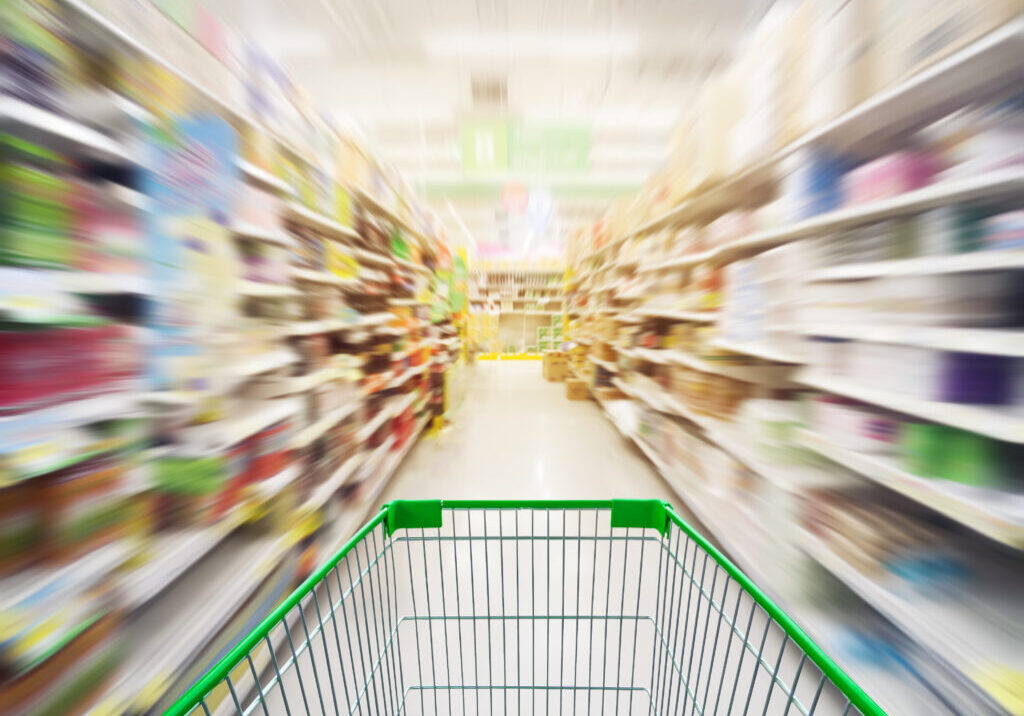 Supermarket store abstract blur background with shopping cart, Supermarket aisle with empty shopping cart