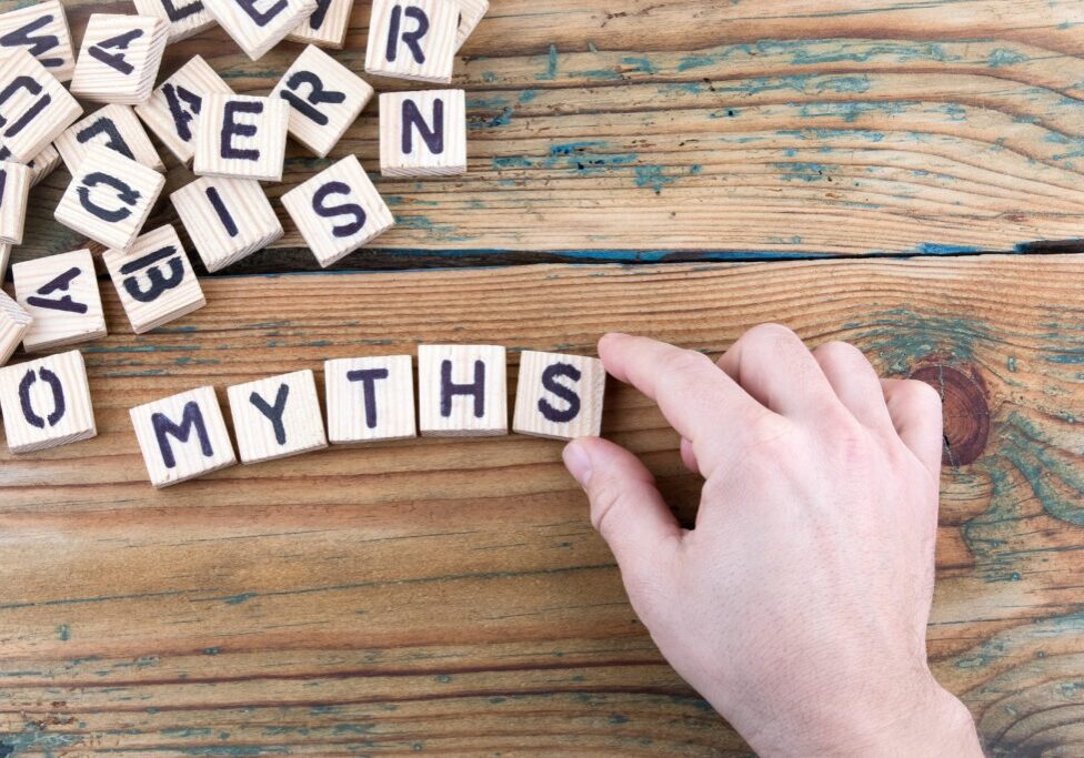 myths. Wooden letters on the office desk, informative and communication background.