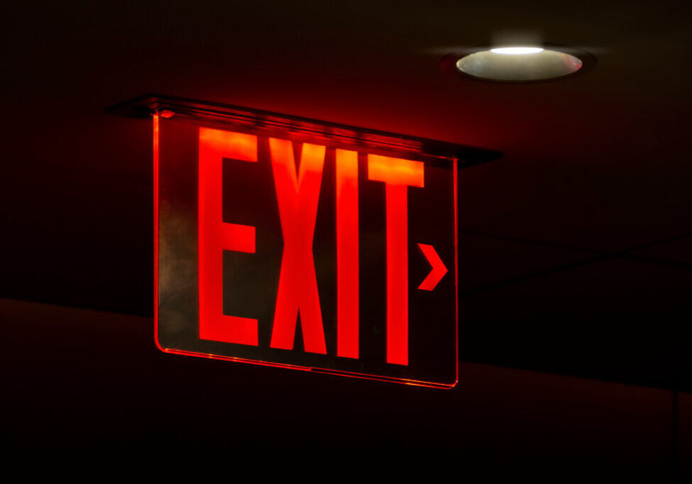 An image of a red lit exit sign