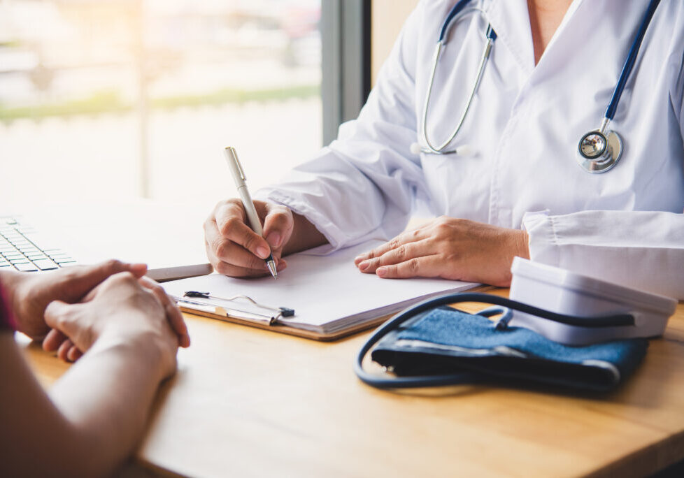 The doctor is discussing with the patient after a physical examination of the results and treatment guidelines.