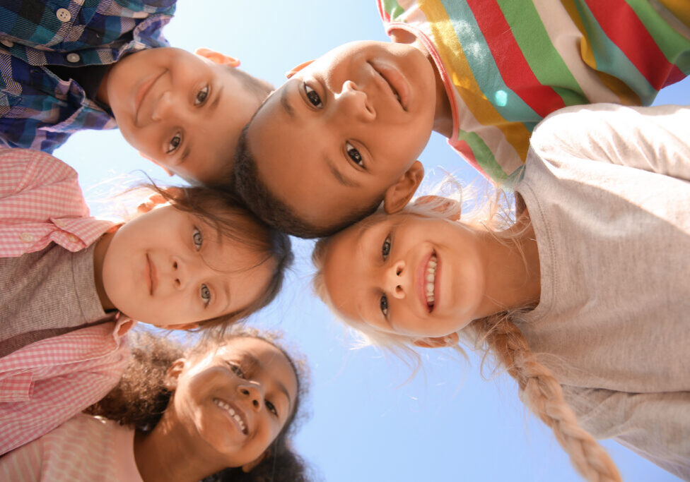 Portrait of cute little children outdoors, bottom view