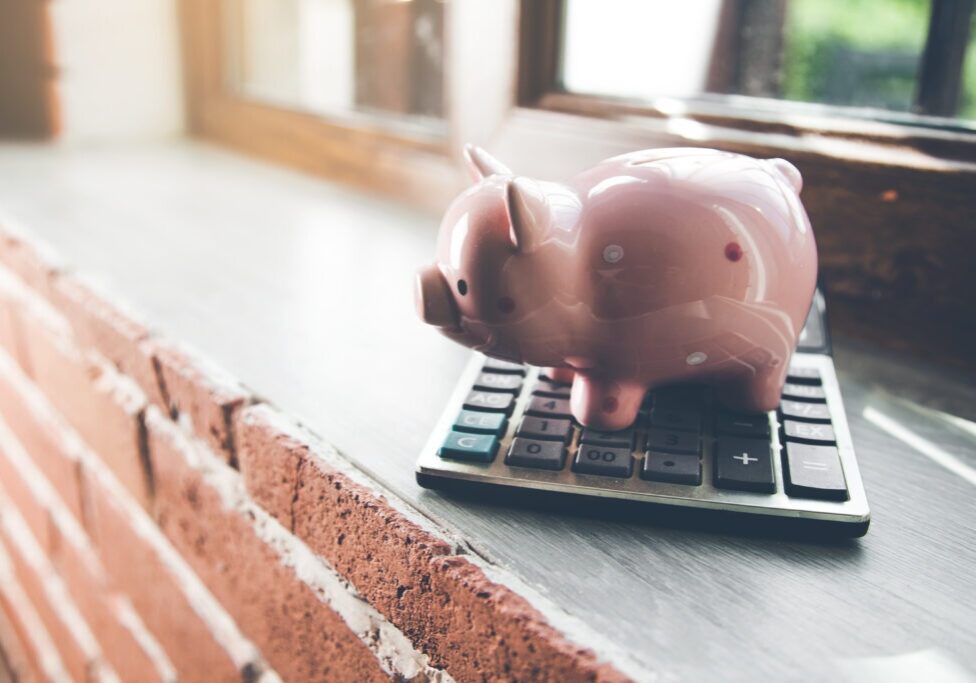 piggy bank with calculator on window
