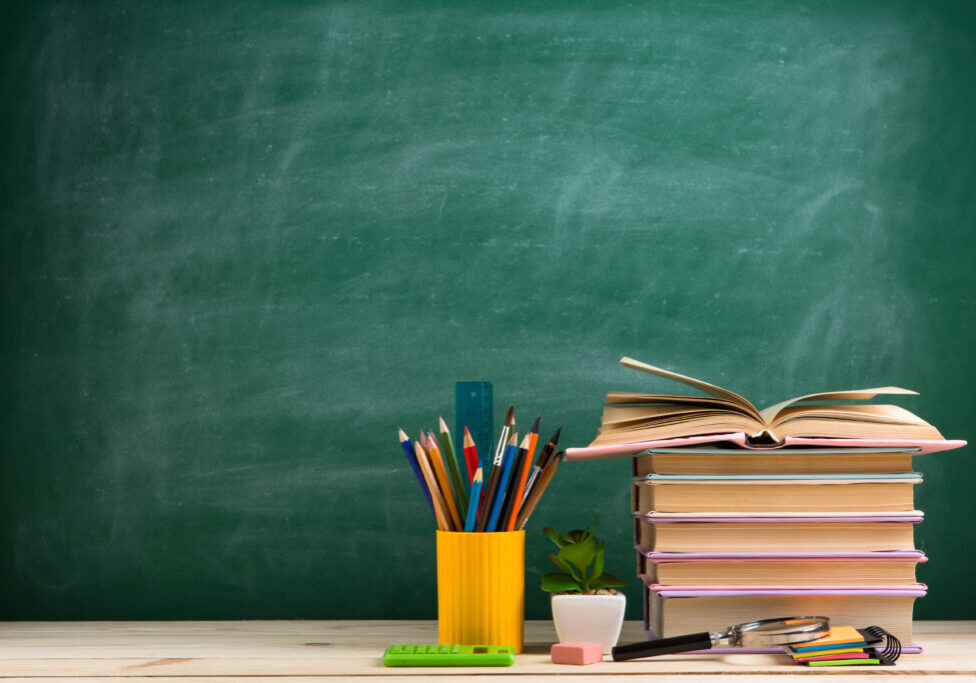 Education and reading concept - group of colorful books on the wooden table