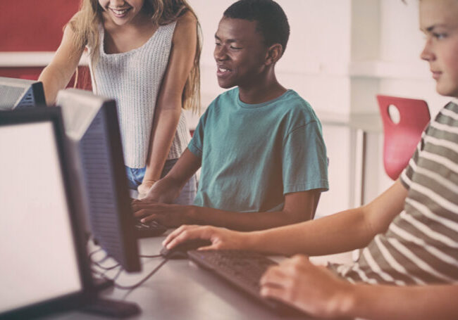 Students using computer in classroom