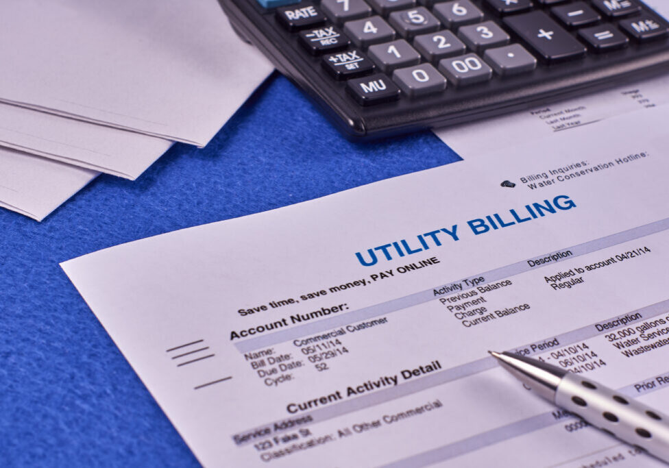 Communal payments. Utility billing sheet, calculator, pen and envelopes on a blue velvet background