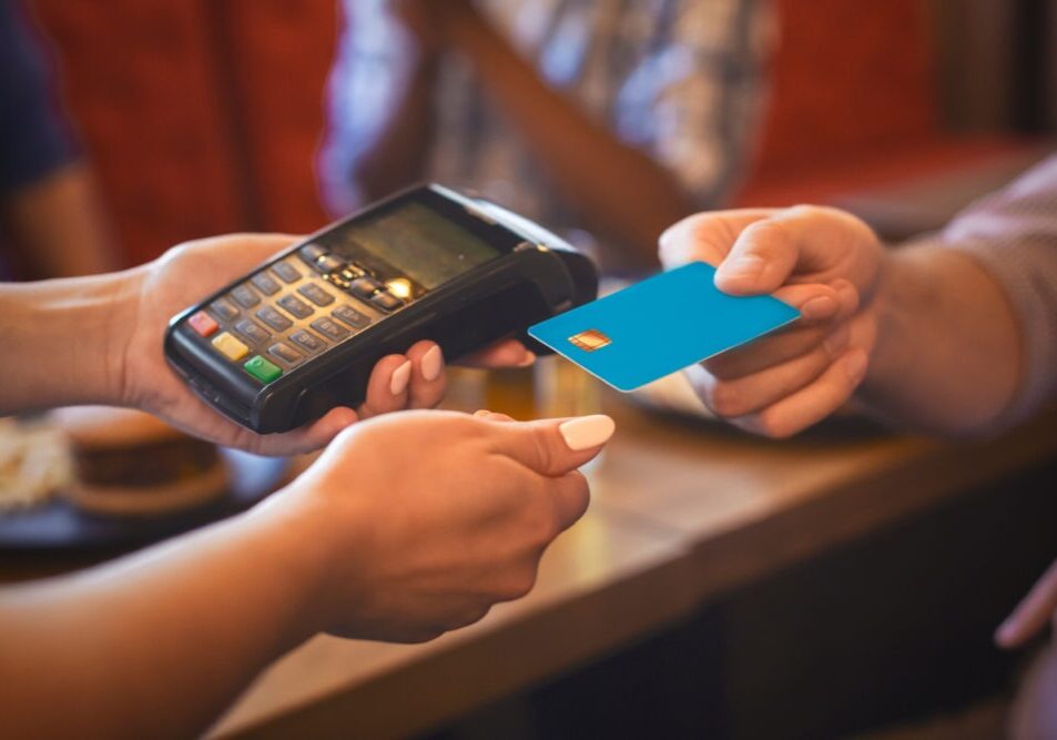 Caucasian Female Waitress Swiping Credit Card At Bar, fast payment concept, cropped