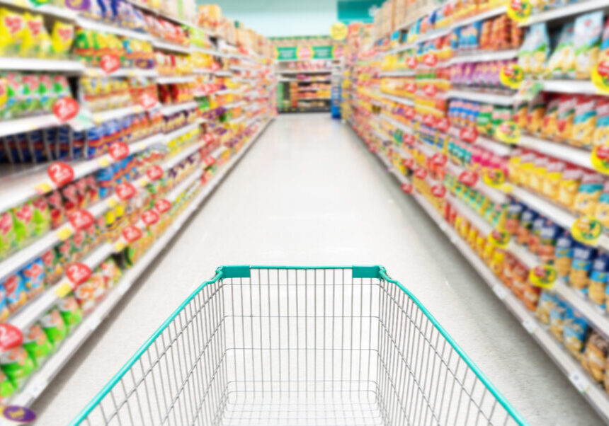 shopping cart with Abstract supermarket grocery store refrigerator blurred defocused background