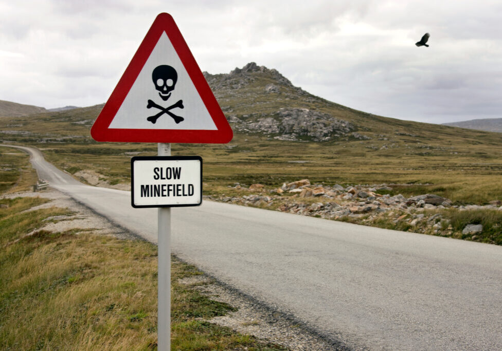 Minefield Sign near Stanley, the capital of the Falkland Islands (Islas Malvinas).  Large areas of land remain unsafe following the Falkland War, a 10-week undeclared war between Argentina and the United Kingdom in 1982.