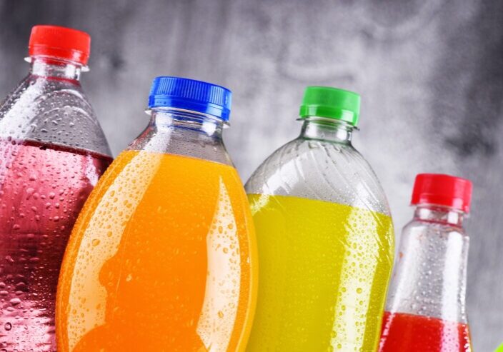 Plastic bottles of assorted carbonated soft drinks in variety of colors