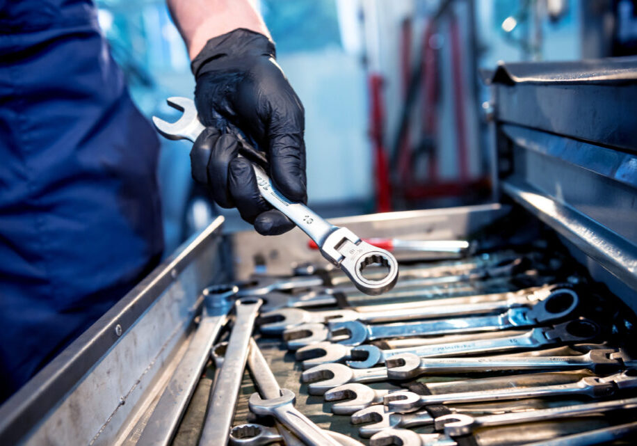 Tools at the hands. Auto repair service.