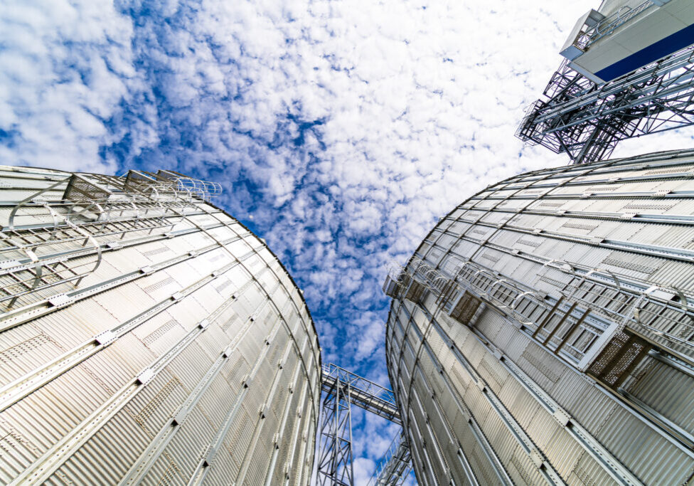 View from below on steel grain elevators. Modern up to date factory. Selective focus.