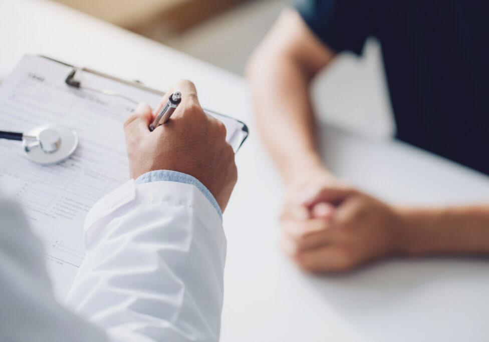 doctor holding test results and consulting patient at desk medical office,  Hospital/ clinic healthcare professionalism concept
