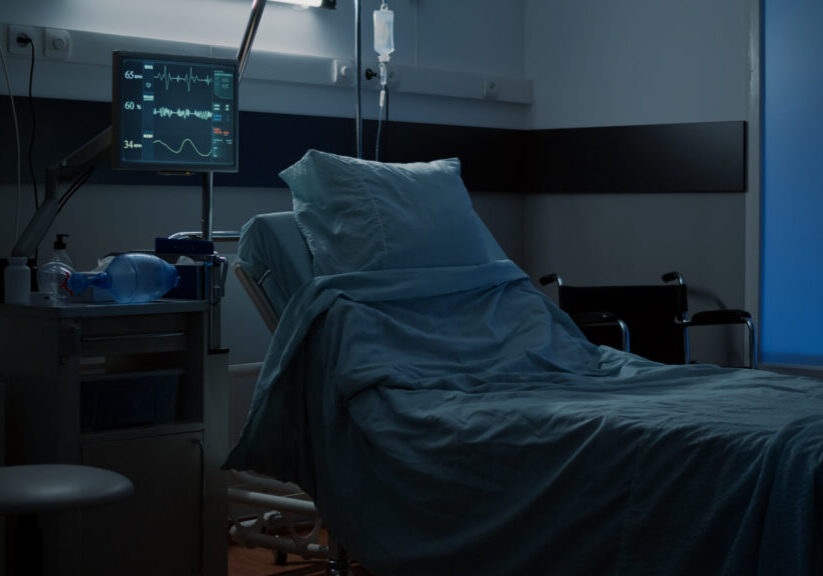 Modern hospital ward with comfortable empty bed used for medical treatment. Nobody in facility room with clinical equipment, monitor, computer, wheelchair, medicine, healing technology