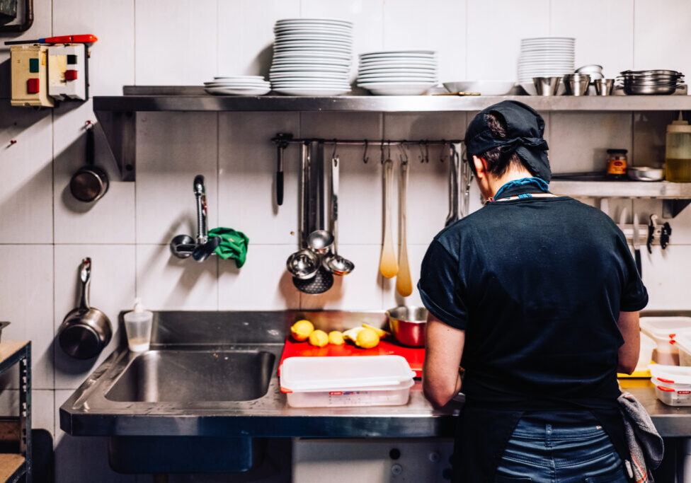 exploited immigrant cook working alone in a kitchen