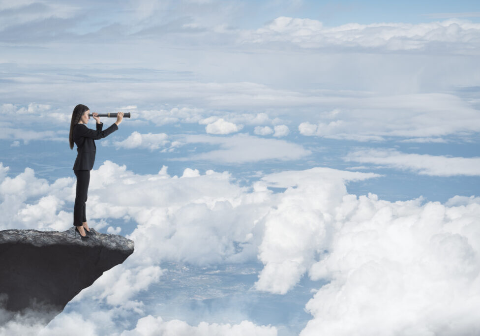 Abstract image of businesswoman with telescope looking into the distance while standing on edge of cliff, mock up place on sky with clouds background. Success, challenge, future and growth concept