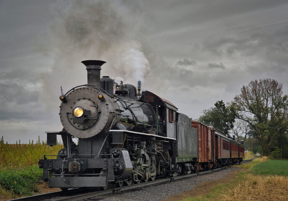 An Antique Restored Steam Freight Train Approaching Head on Blowing Smoke and Steam