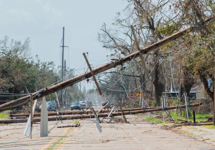 Close up of power lines and telephone poles down after a hurricane.