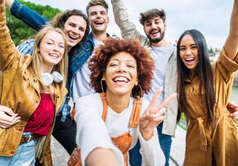 Multiracial group of friends taking selfie pic outside - Happy different young people having fun walking in city center - Youth lifestyle concept with guys and girls enjoying day out together