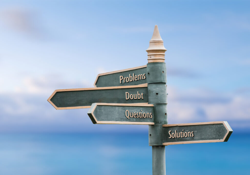 problems doubt questions solutions four word quote written on fancy steel signpost outdoors by the sea. Soft Blue ocean bokeh background.