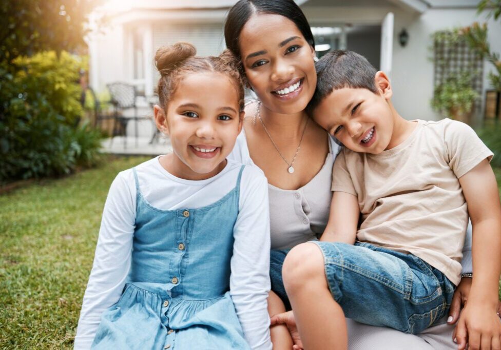 Family bonding, smiling and enjoying new house, garden and backyard as real estate investors, homeowners and buyers. Portrait of single mother, son and daughter with home insurance sitting together.