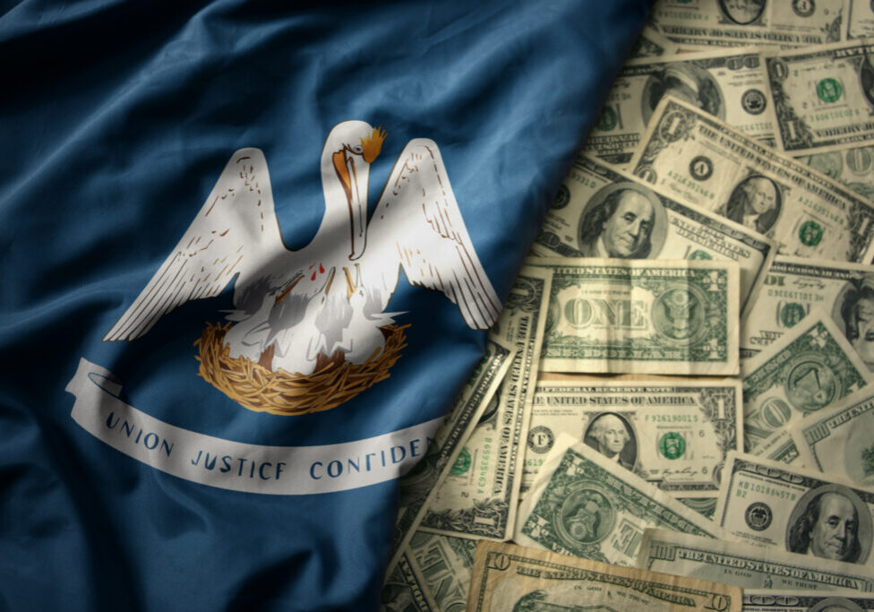 big colorful waving national flag of louisiana state on a american dollar money background. finance concept